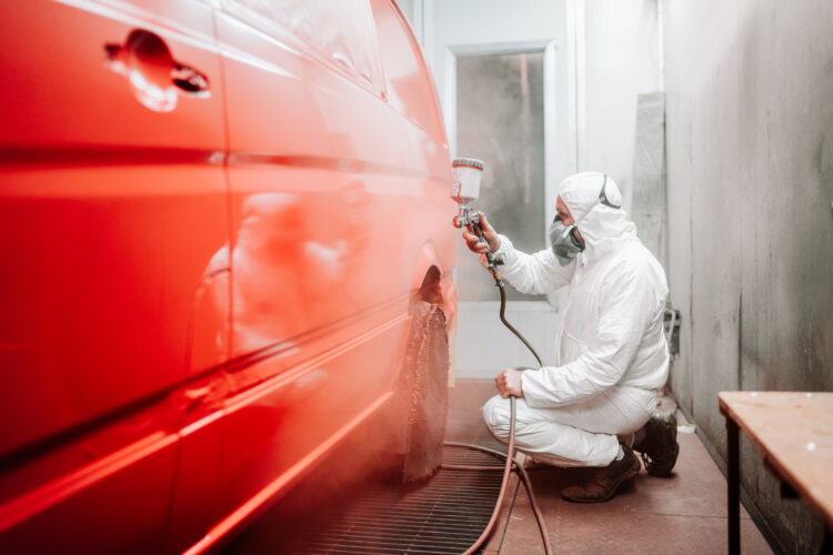 man respraying bodywork of vehicle